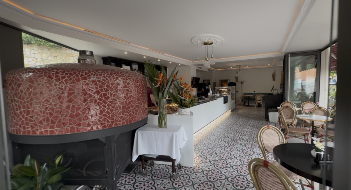Inside La Villa d'Èze — traditional pizza oven and patterned tile floor